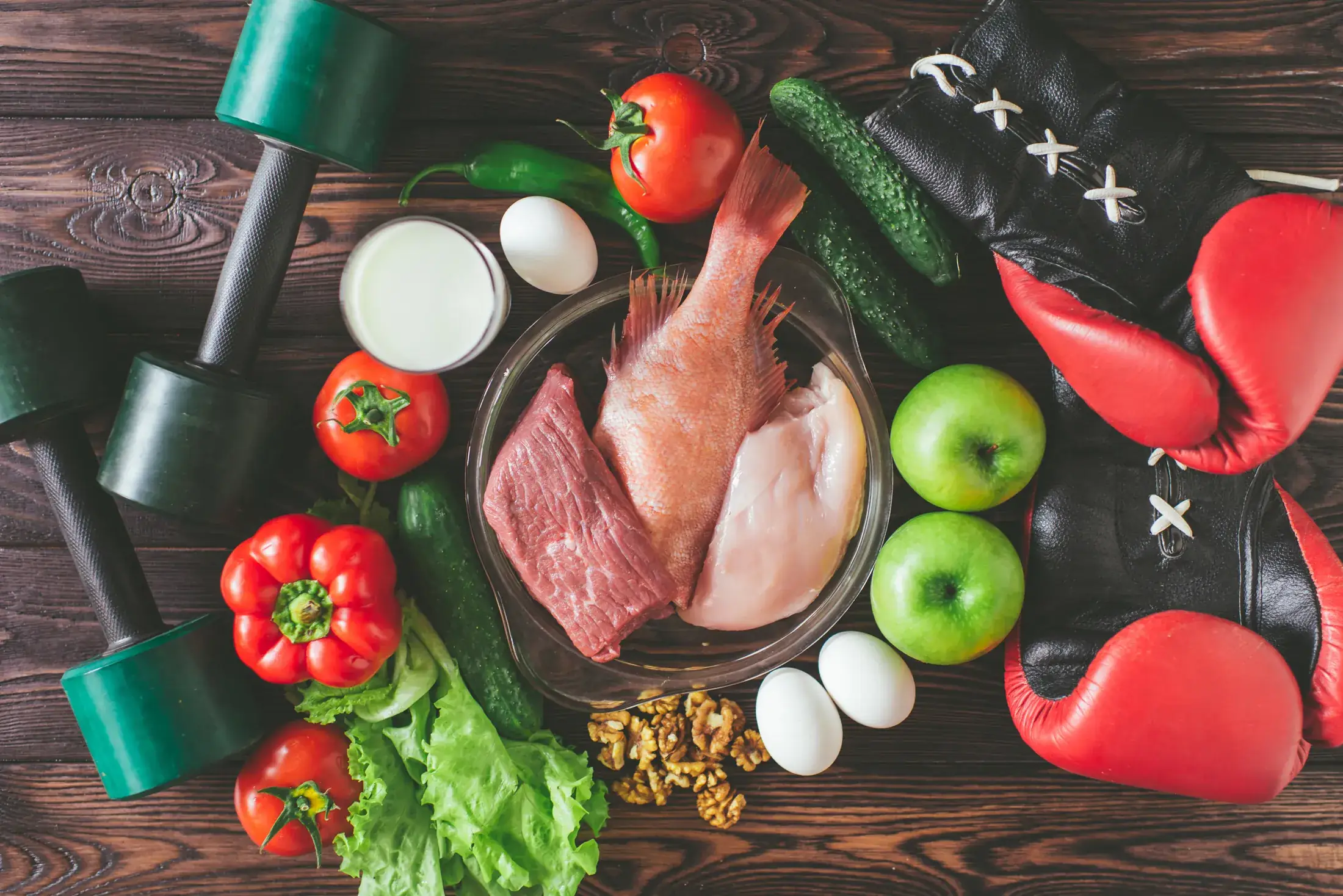Training equipment laid out beside fresh produce, meat and eggs