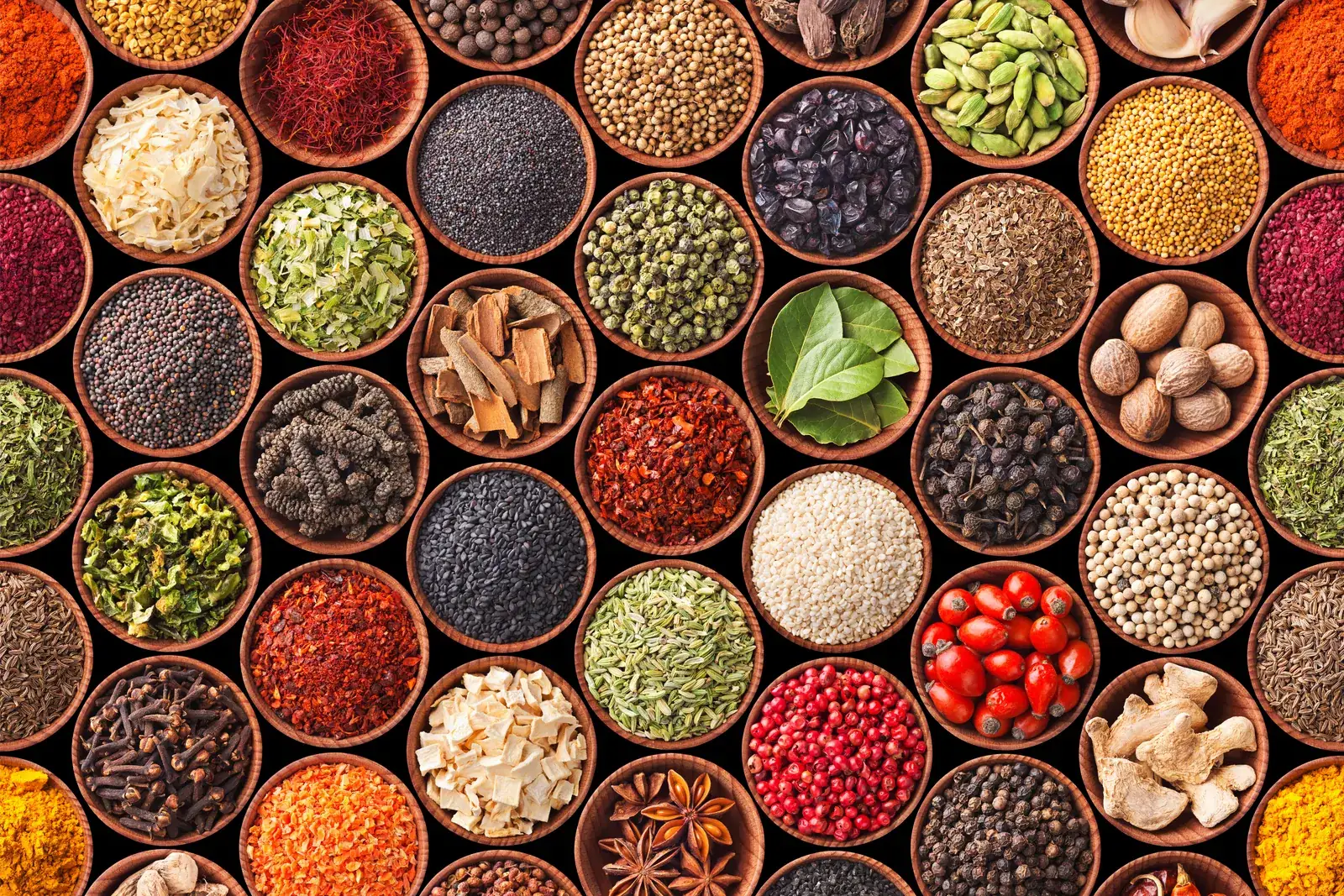 Bowls of spices, grains and legumes arranged in a grid